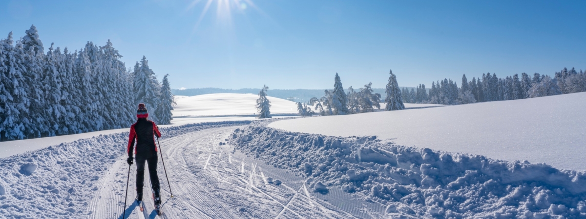 beatiful active senior woman cross-country skiing in fresh fallen powder snow in the Allgau alps near Immenstadt, Bavaria, Germany