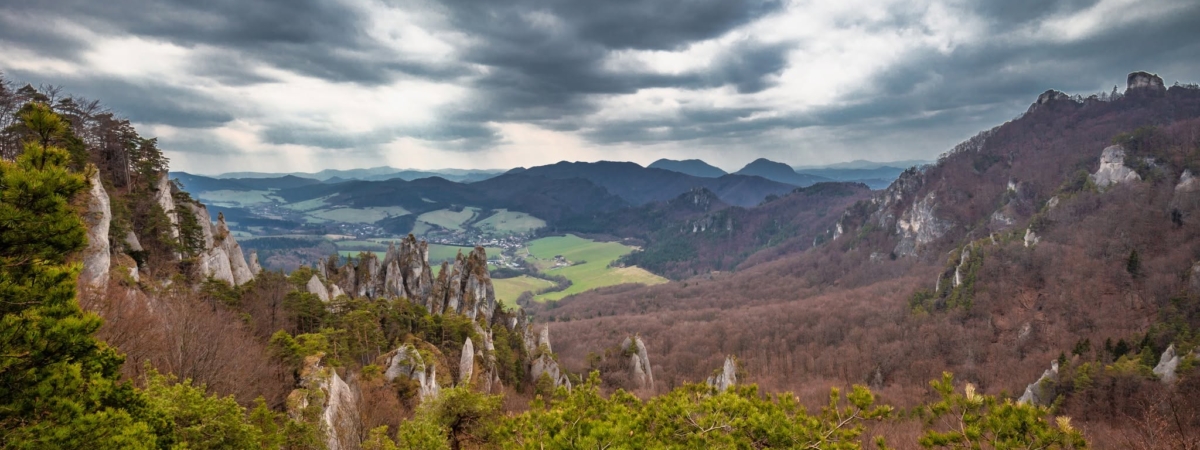 View of the mountainous landscape with rock formations in partly cloudy weather. National Nature Reserve Sulov Rocks, Slovakia, Europe.
